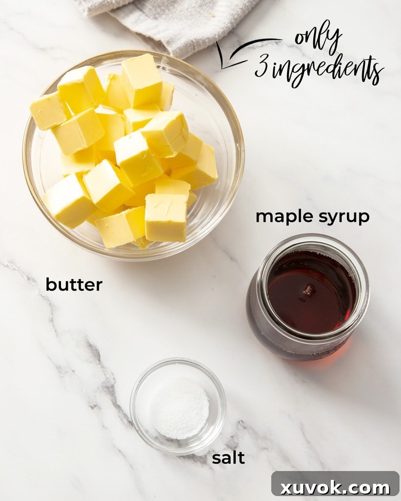 Glass bowls containing the three simple ingredients for whipped maple butter: unsalted butter, pure maple syrup, and a small pinch of salt, neatly arranged on a clean surface.