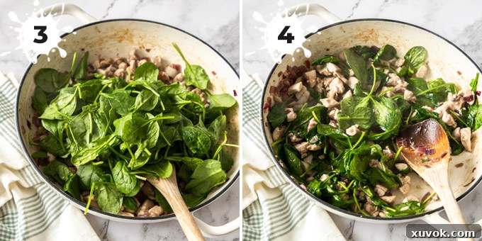 A white pan containing a mixture of chicken, spinach, and mushrooms being stirred with a wooden spoon, showcasing the rich textures and colors of the filling.