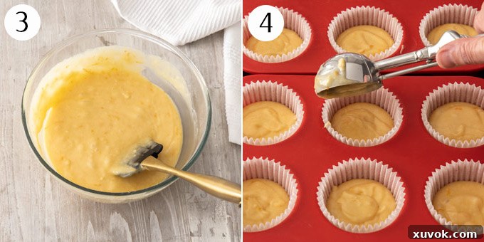 Portioning cupcake batter evenly between cupcake cases in a muffin tin using an ice cream scoop.