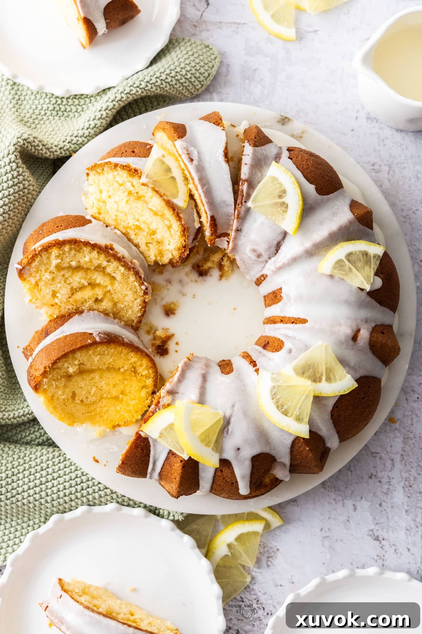 Top down view of the lemon butter cake with half cut into slices, showcasing its elegant design and moist texture.
