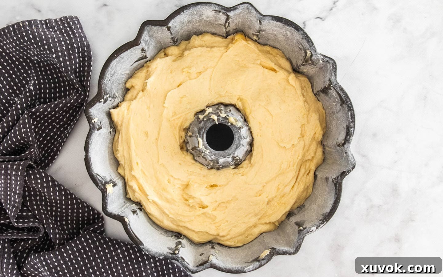 The bundt pan filled with perfectly layered batter, ready for the oven.
