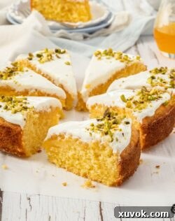 Closeup of a slice of Greek Orange Semolina Cake with more slices surrounding it