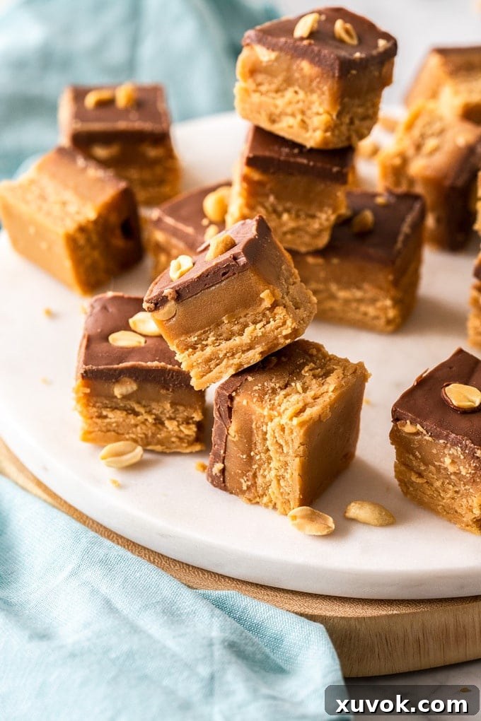 Pieces of caramel peanut fudge stacked up on a white platter