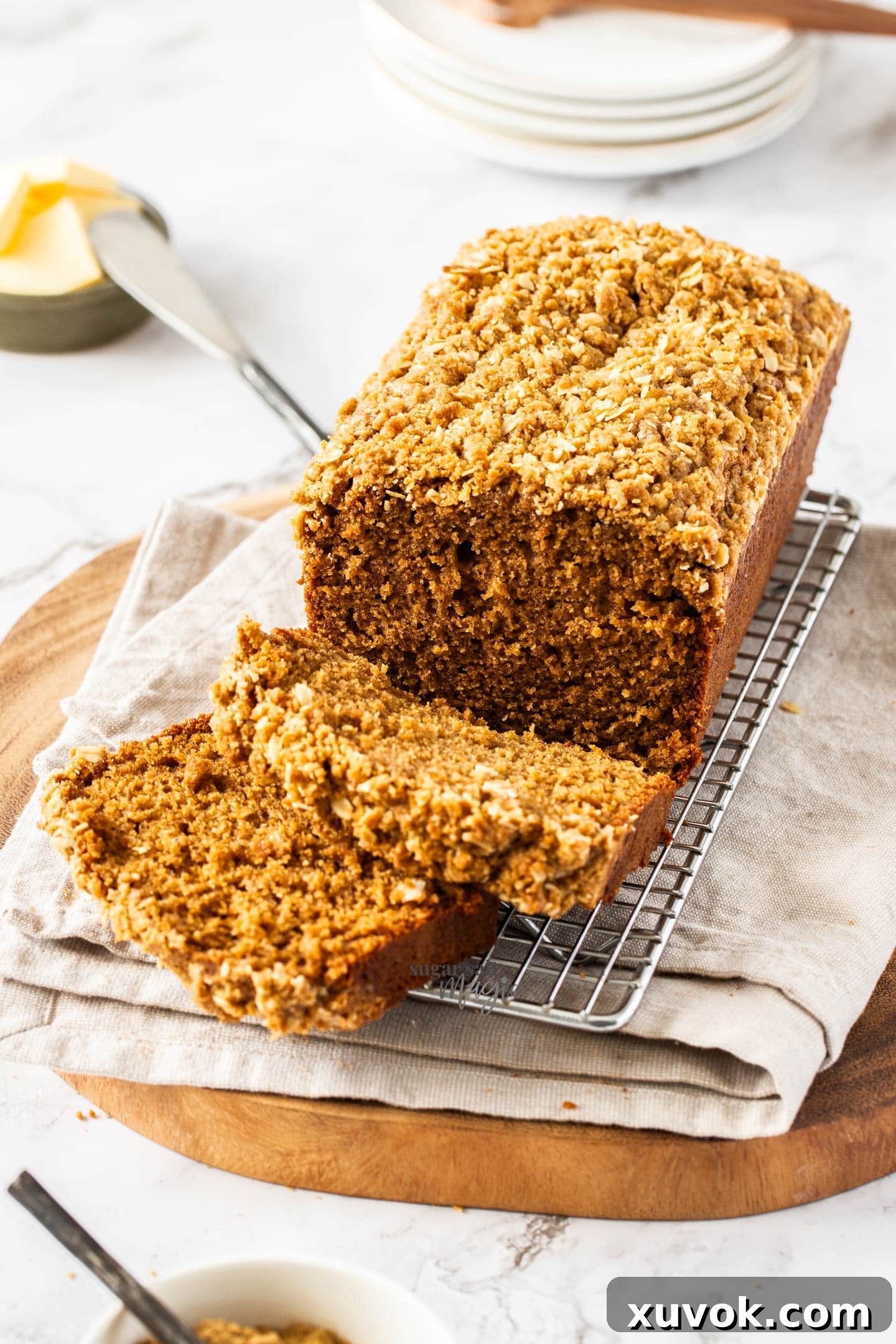 The ginger loaf cake on a wire rack with two slices cut away.