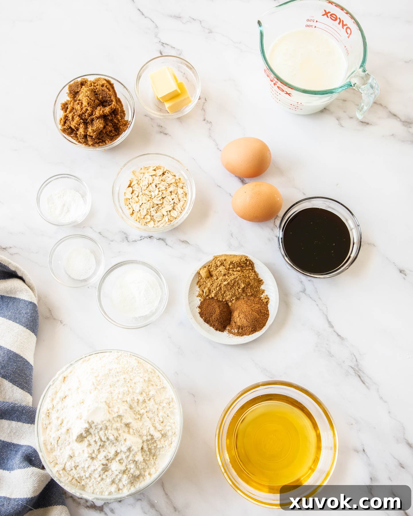 Ingredients for ginger loaf cake on a marble surface.
