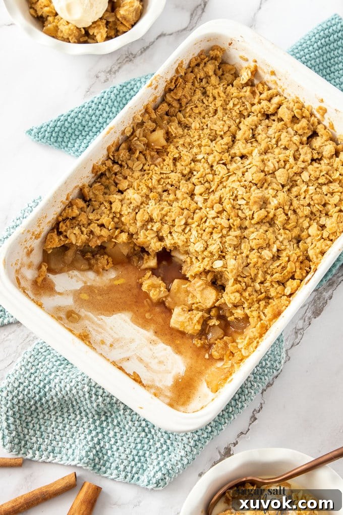 Top down view of apple crumble in a white rectangular dish.