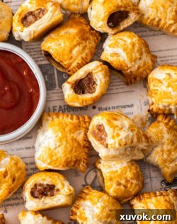 Top down view of a batch of sausage rolls.