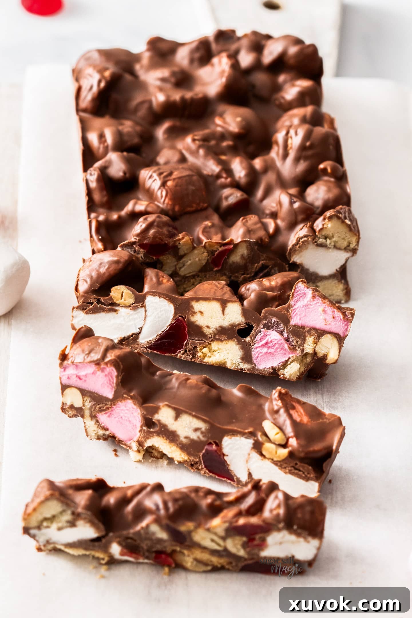 A beautifully arranged batch of homemade rocky road, featuring three perfectly cut slices ready to be enjoyed.