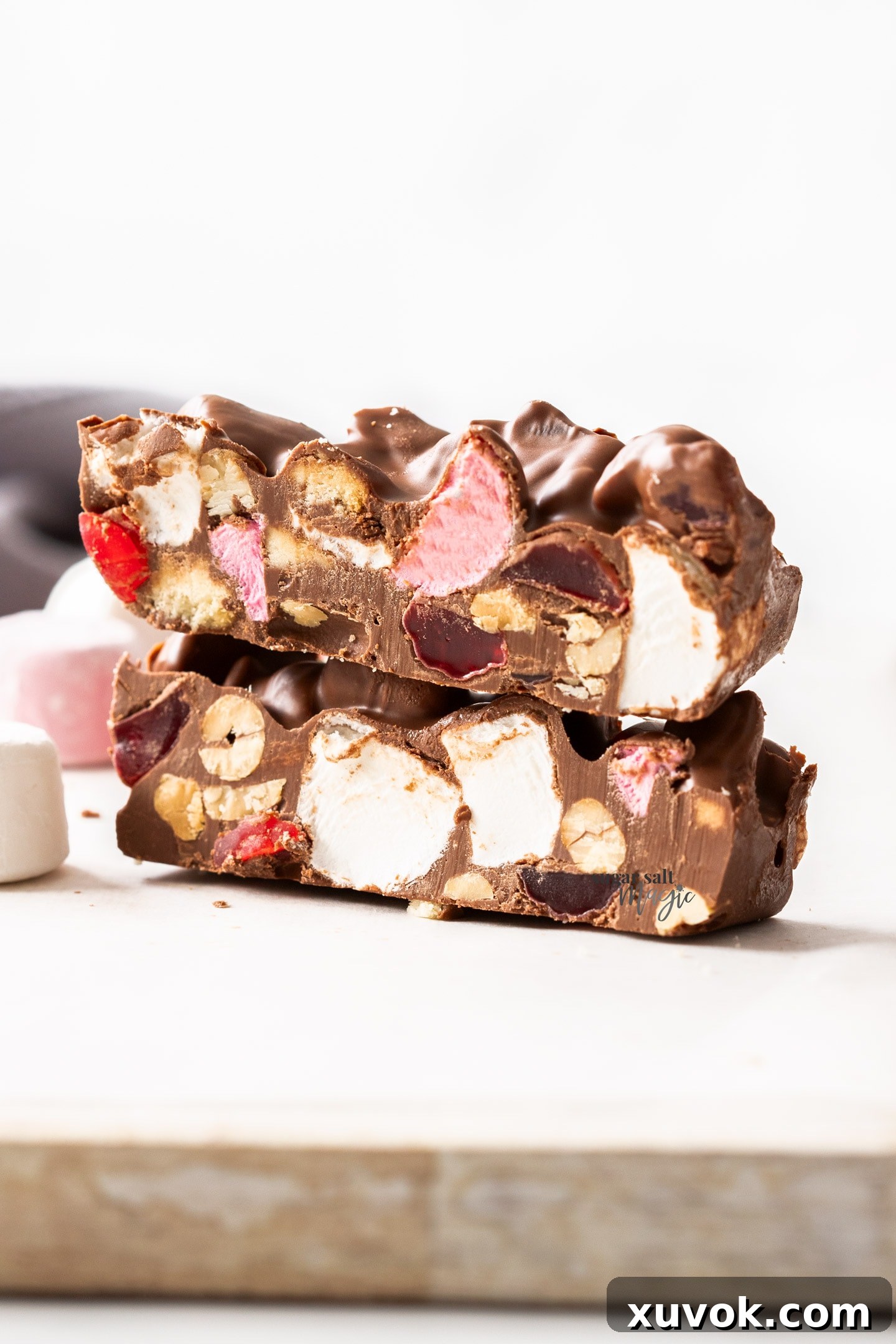 Two enticing slices of homemade rocky road, elegantly stacked to showcase their delightful layers of chocolate and mix-ins.