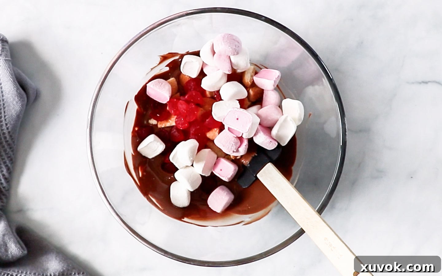 Rocky road ingredients being mixed in a bowl.