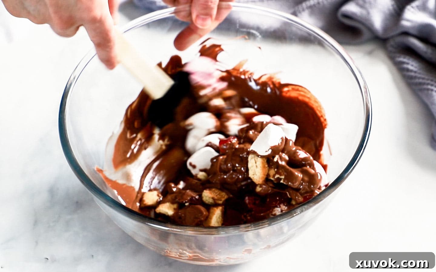 Rocky road ingredients being mixed in a bowl.