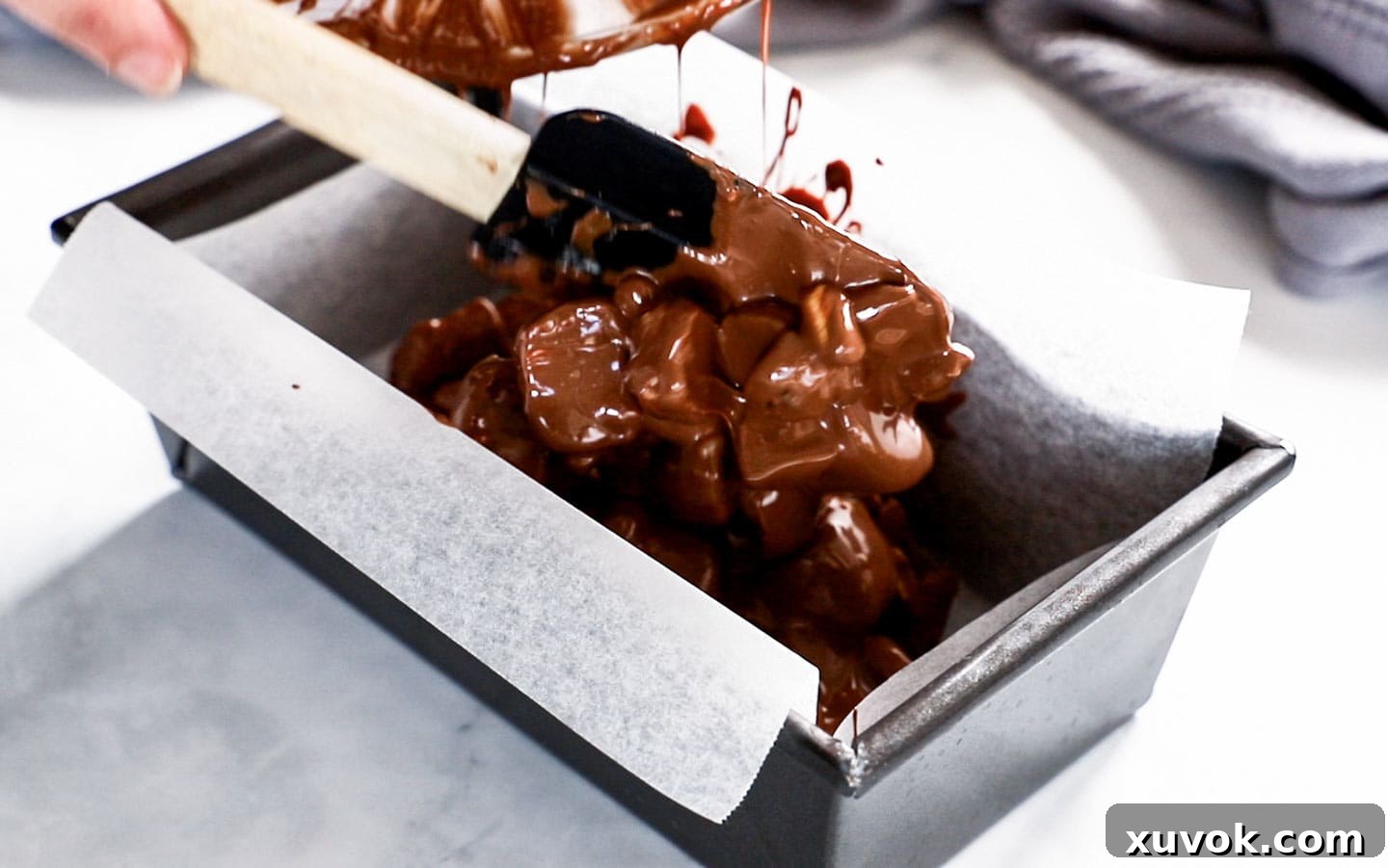 Rocky road being decanted into a loaf pan.