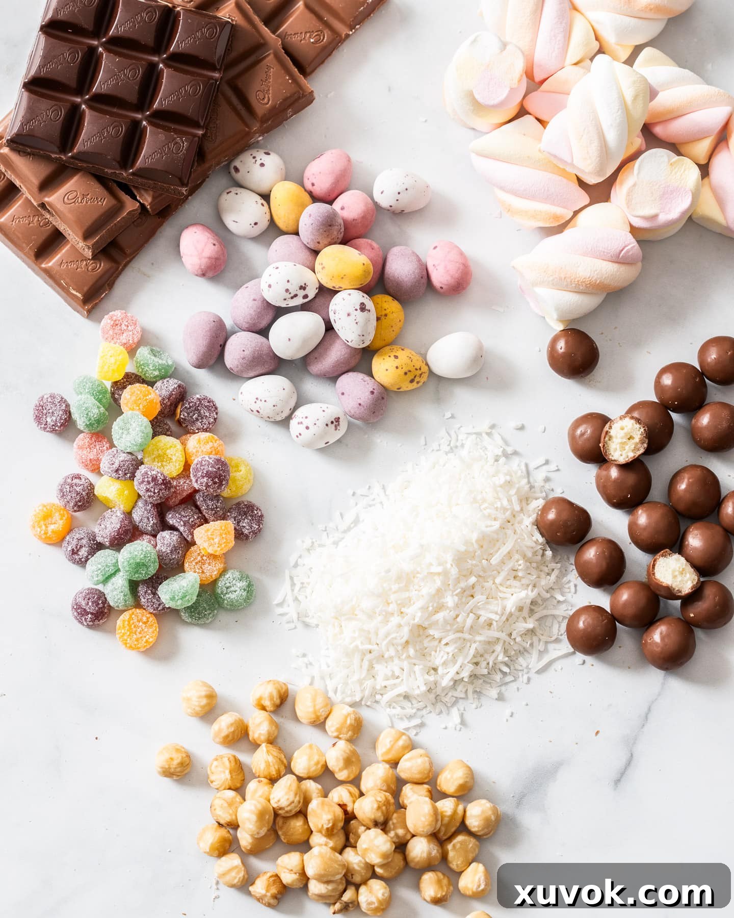 A selection of ingredients specifically chosen for an Easter rocky road recipe, including colorful candies and mini eggs.
