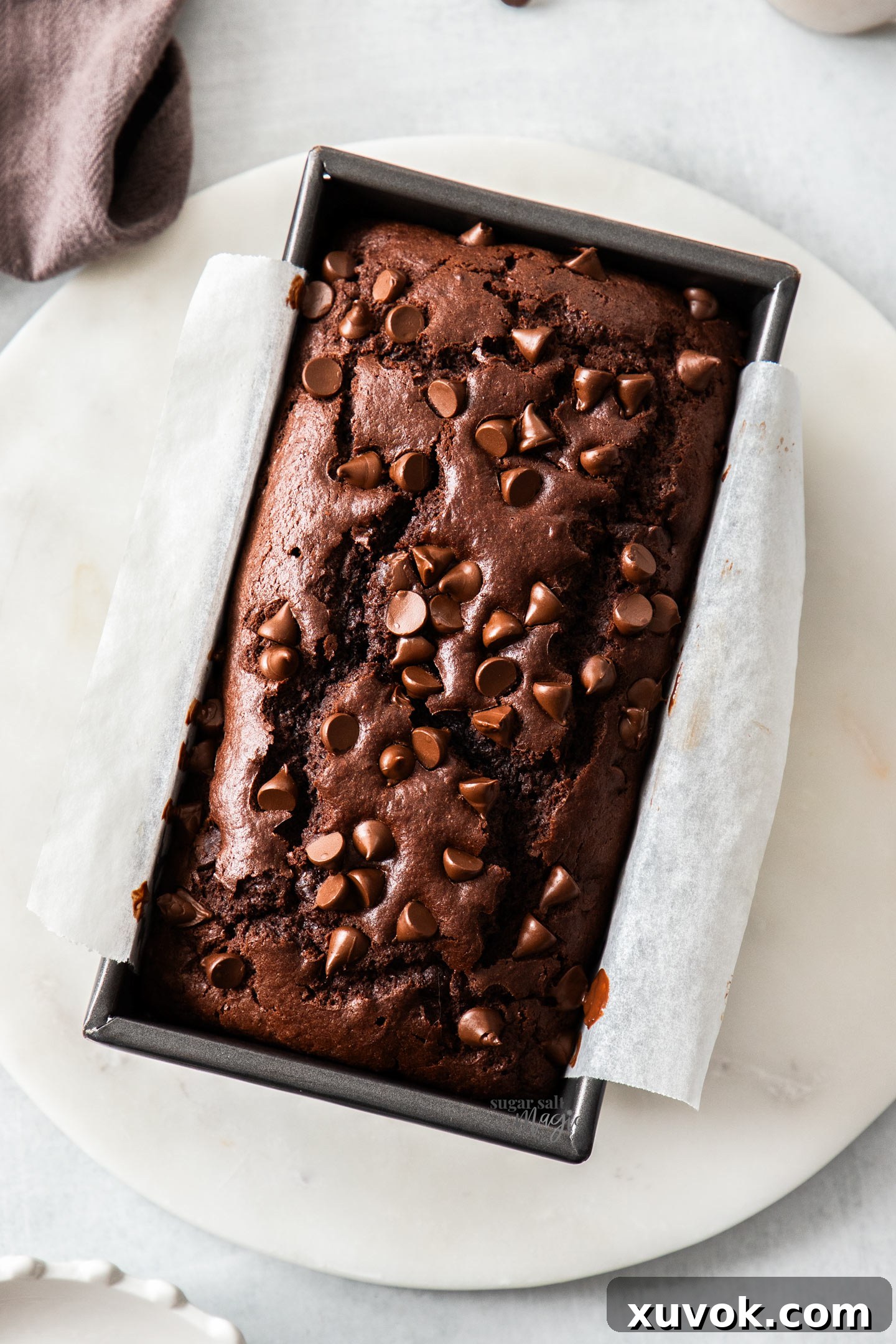 Top down view of the baked chocolate bread in a pan. A quick and easy chocolate loaf cake recipe.