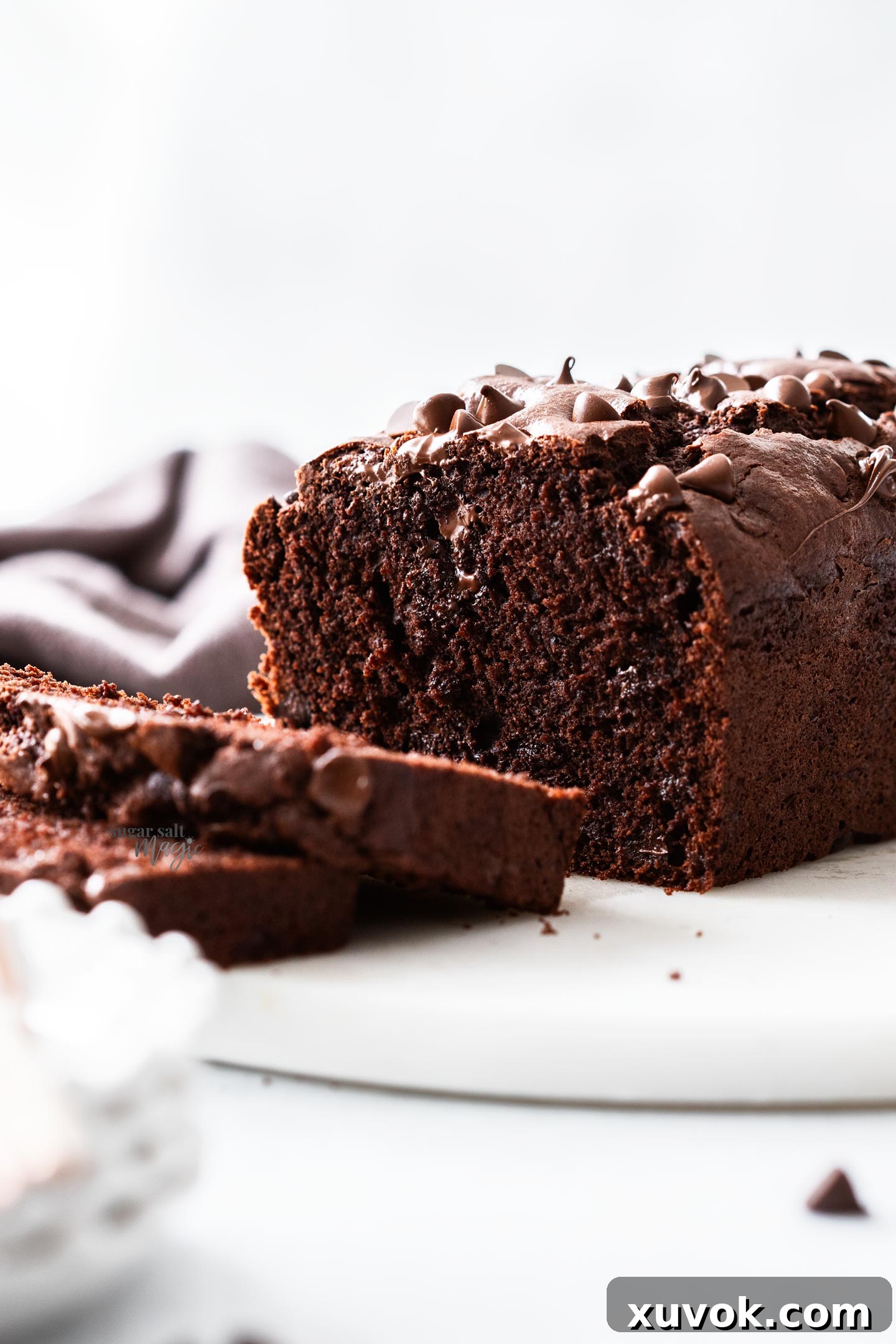 The chocolate loaf cake sliced to show the inside, emphasizing its rich color and chocolate chips.