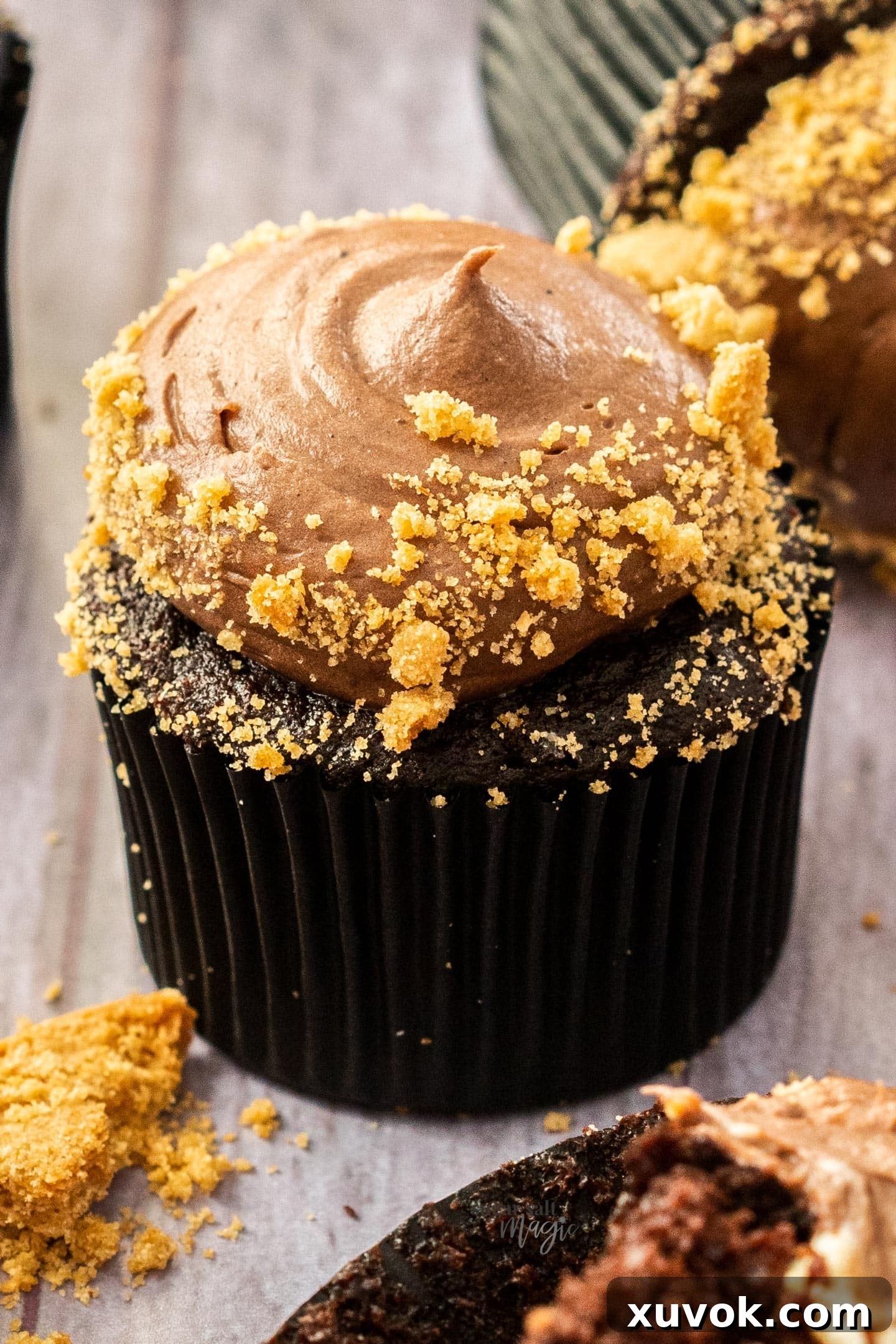 An extreme close-up shot of the rich, velvety chocolate cream cheese frosting, showcasing its smooth texture and inviting swirls.