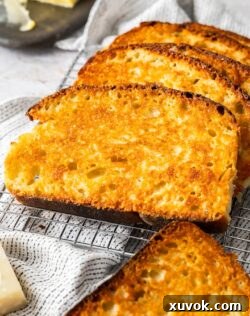 A batch of sizzler cheese toast stacked one against the other, ready to be served.