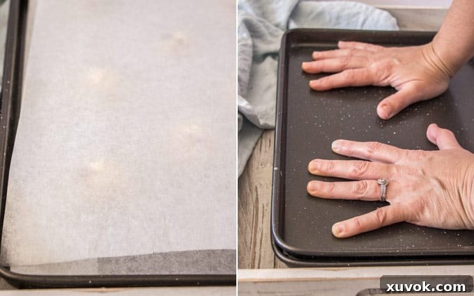 Using one baking tin on top of another to flatten cookies, a clever technique for even results.