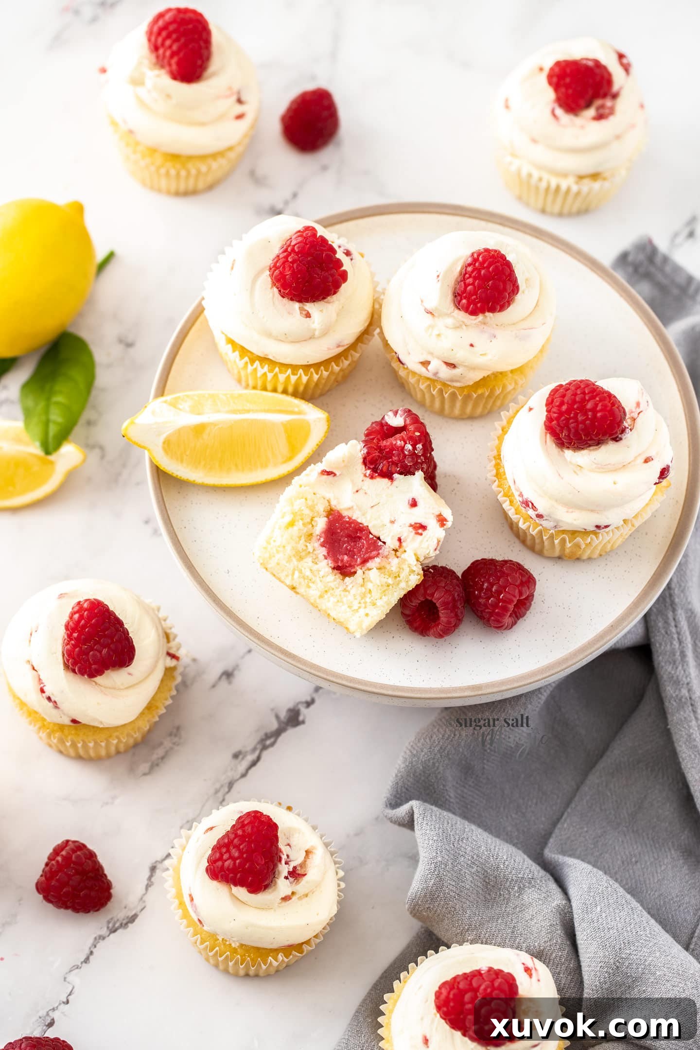 Birdseye view of a batch of cupcakes with one cut open.