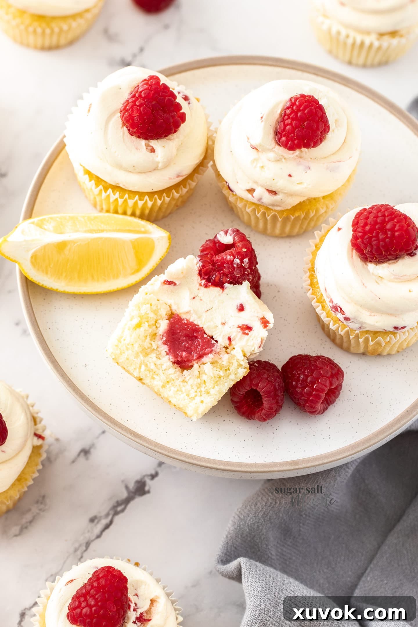 Birdseye view of a batch of cupcakes with one cut open.