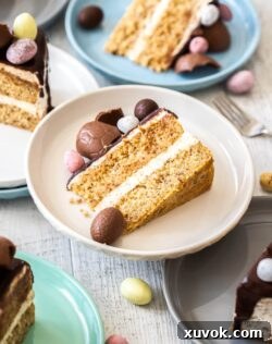 Closeup of a slice of hazelnut cake on a white plate, revealing its delicate layers and rich texture.