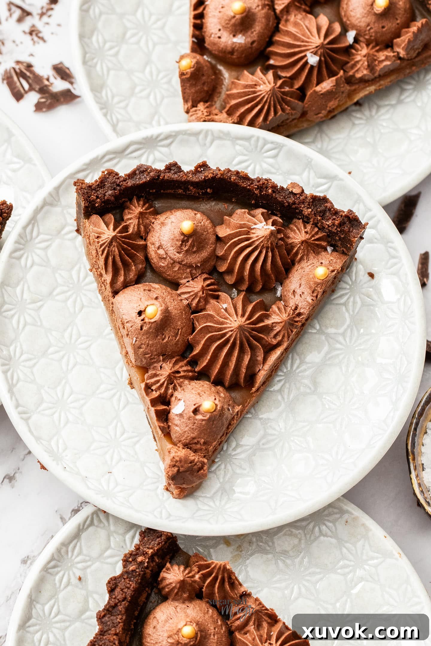 Top down view of a slice of chocolate caramel tart.