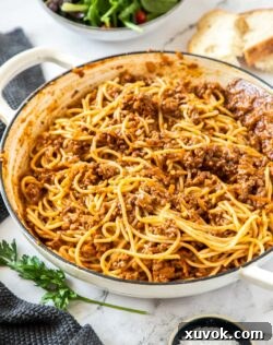 A white casserole dish filled with spaghetti bolognese