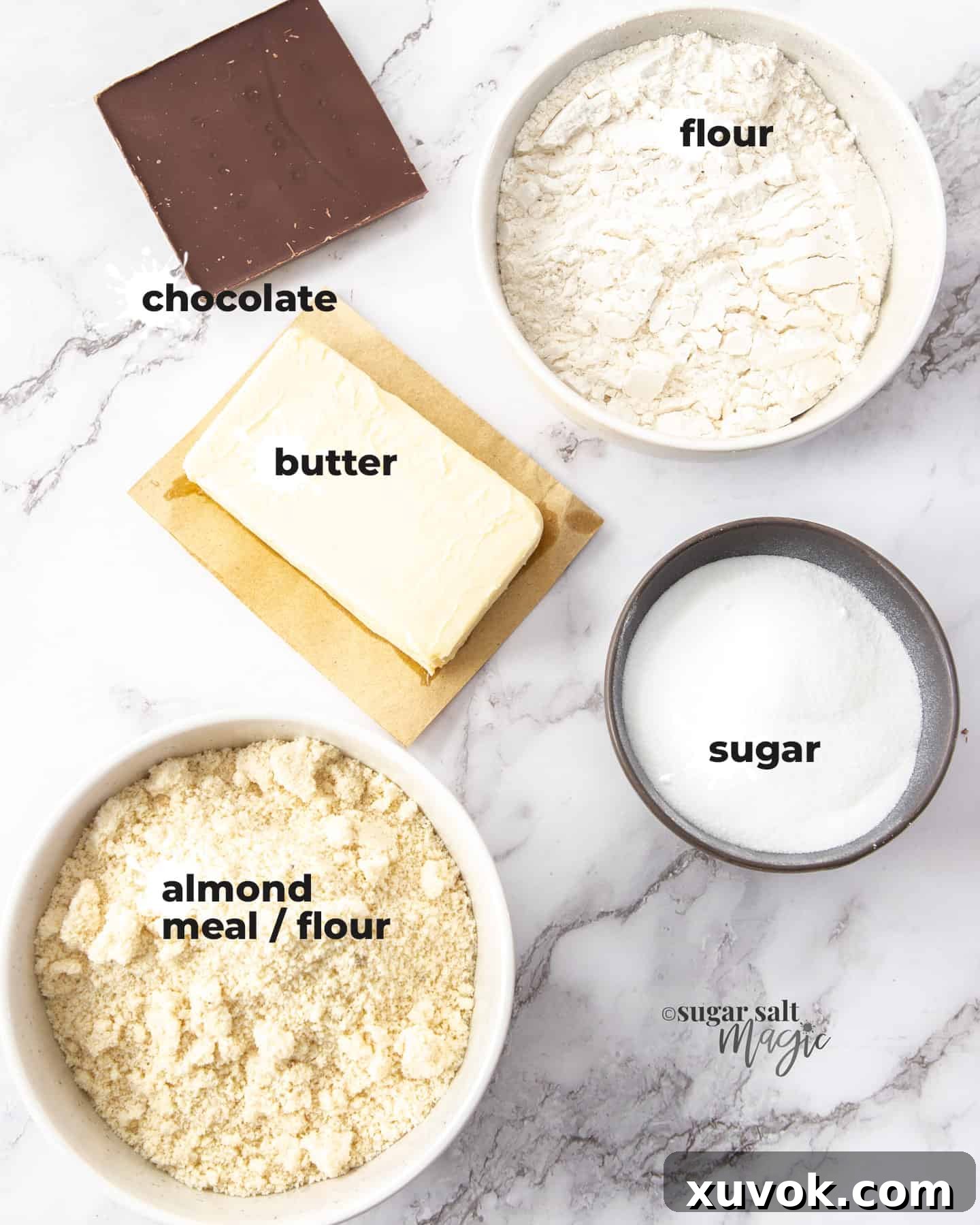 Carefully measured ingredients for Baci Di Dama arranged on a pristine marble surface, highlighting their quality and simplicity.