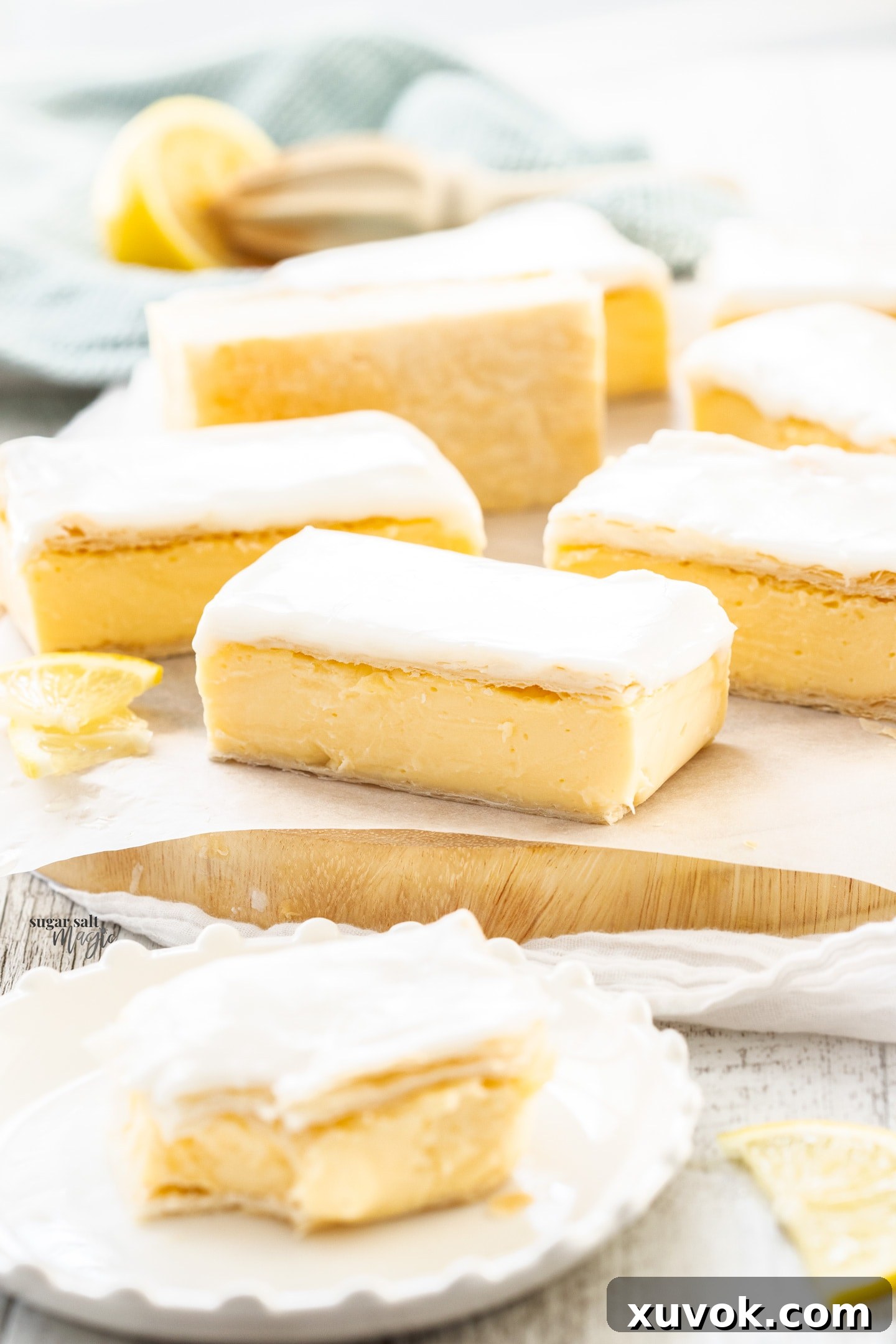 A single piece of lemon custard slice on a wooden platter, ready to be enjoyed.