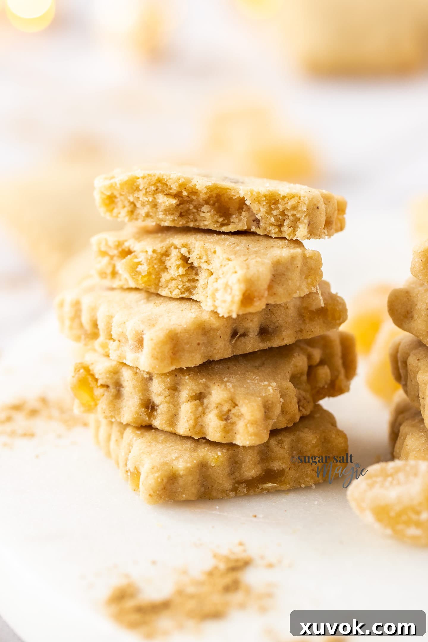 A stack of ginger shortbread cookies on a white plate, ready to be served or stored.