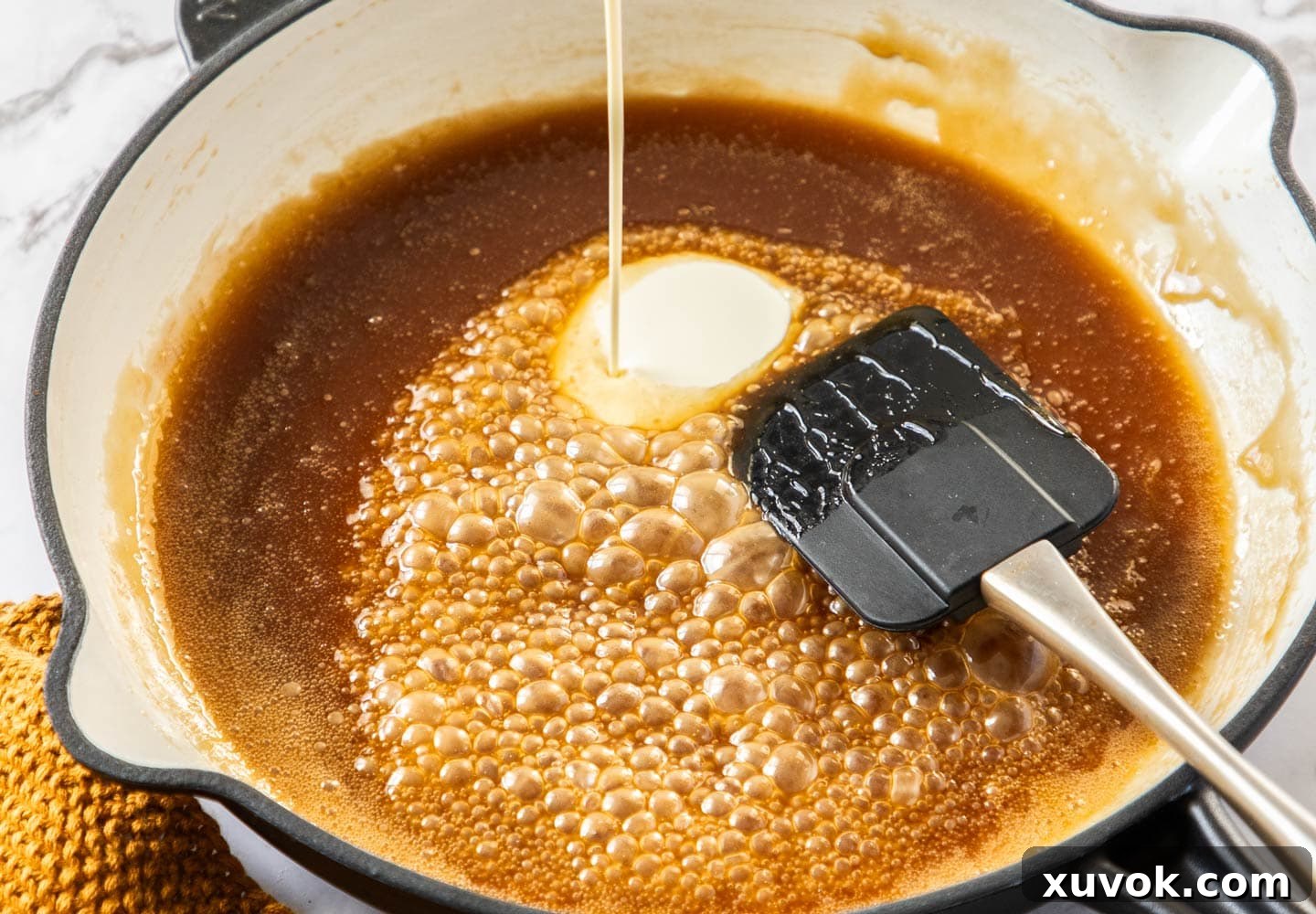 The caramel sauce bubbling in a pan.
