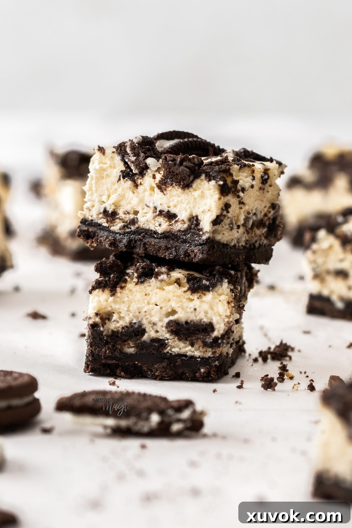 Two perfectly stacked Oreo cheesecake bars, showcasing their irresistible layers and deliciousness.
