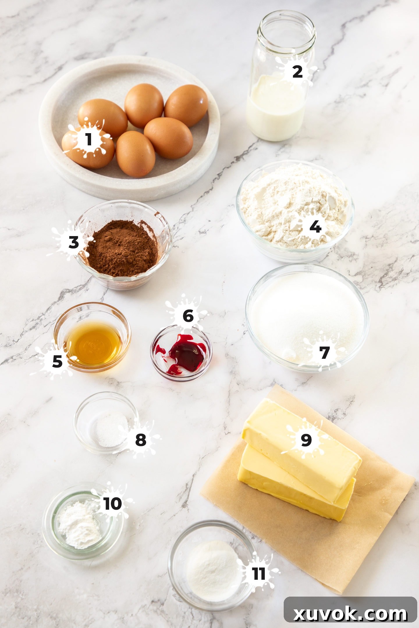 A curated collection of fresh ingredients for Red Velvet Pound Cake laid out on a elegant white marble surface.