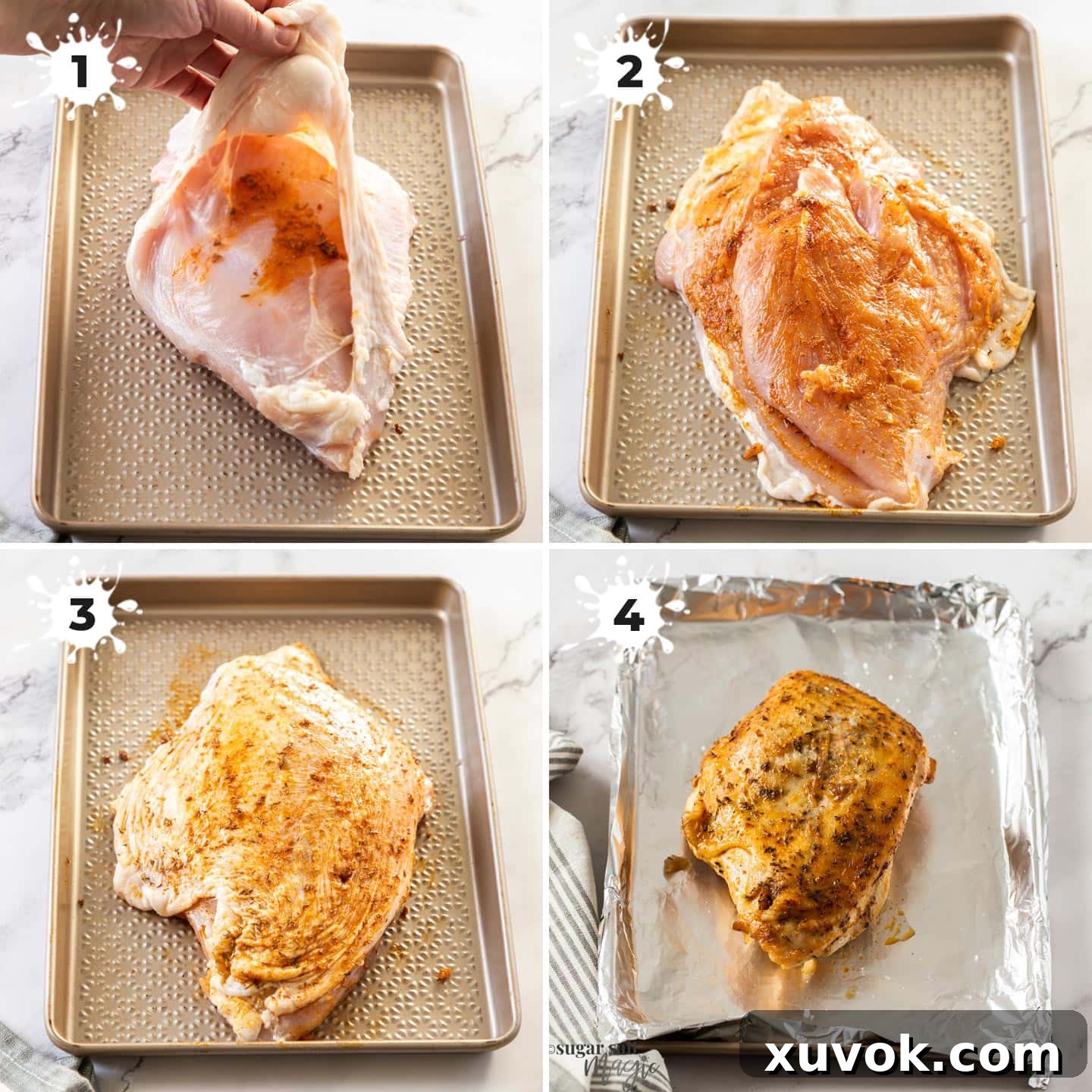 Raw turkey breast on a baking tray being covered with a rich spice paste. The paste is spread generously over the skin and crevices, ensuring maximum flavor penetration.