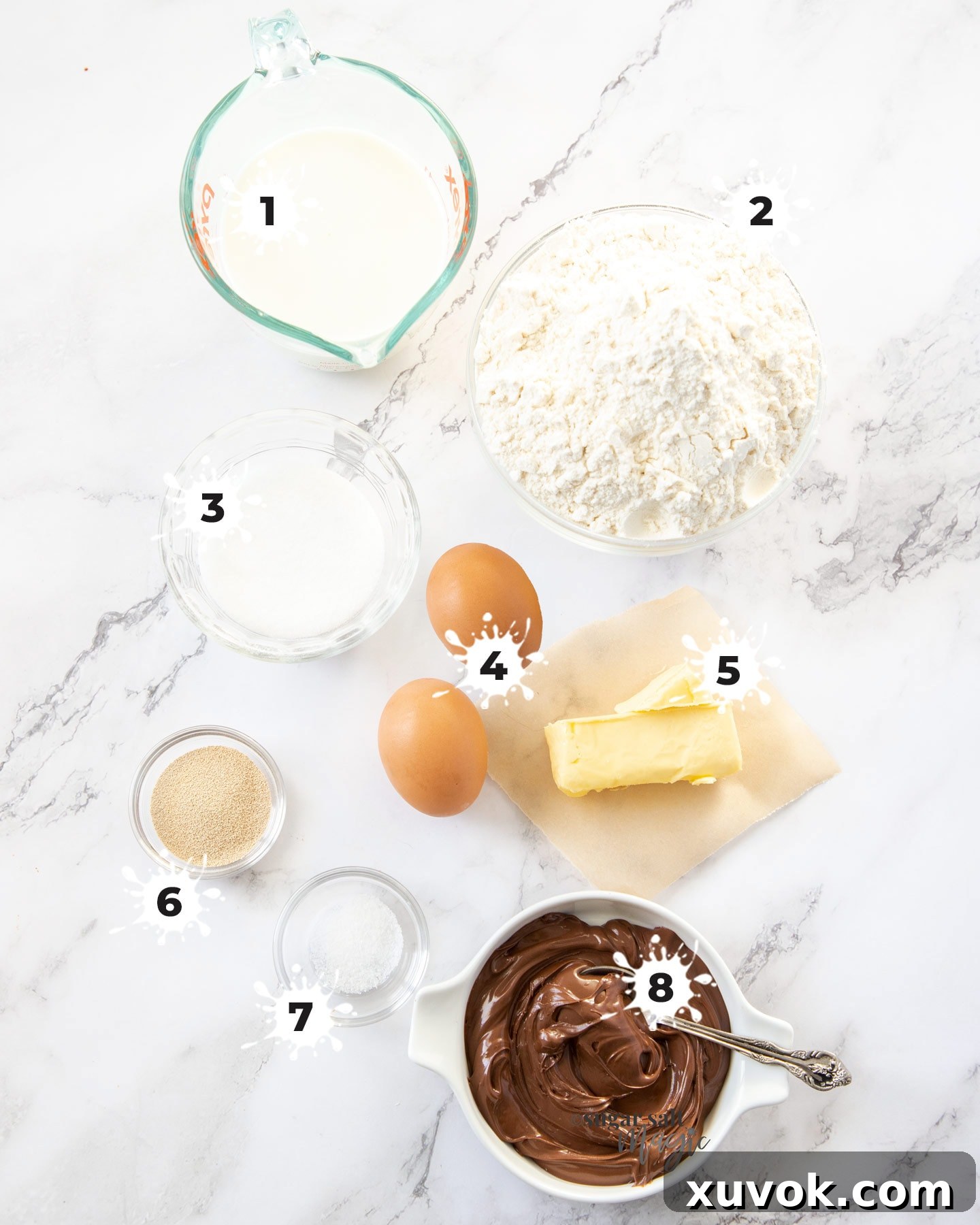 Ingredients laid out for Nutella star bread including butter, milk, flour, yeast, sugar, salt, eggs, and Nutella