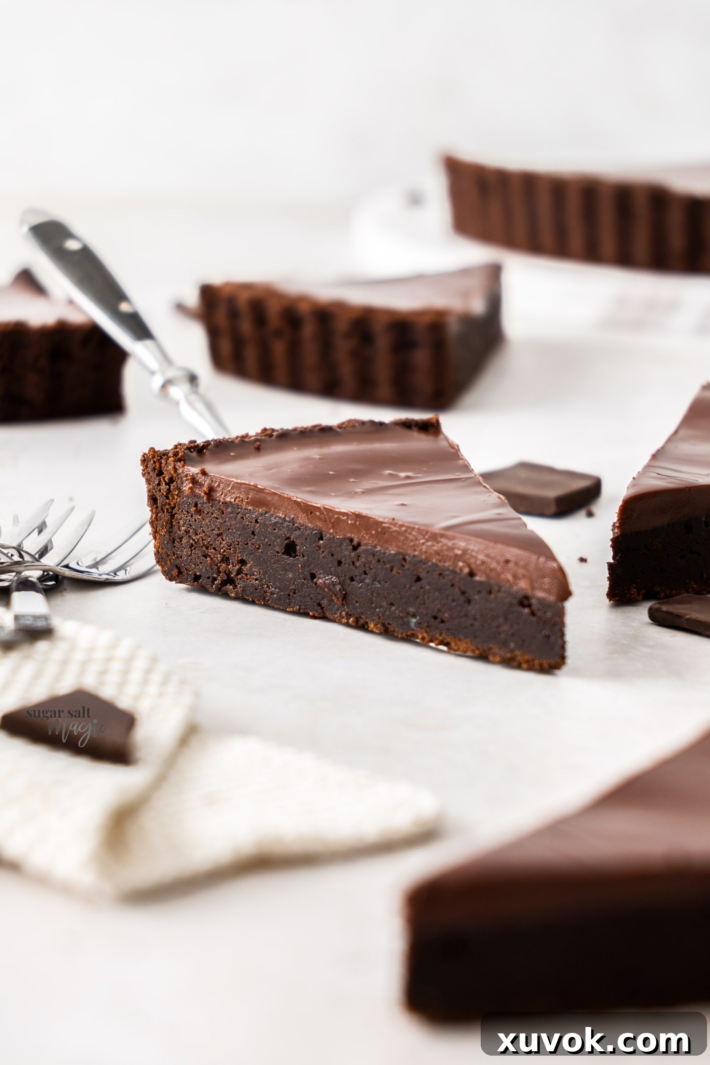 A slice of brownie tart resting on an elegant cake server, ready to be enjoyed.