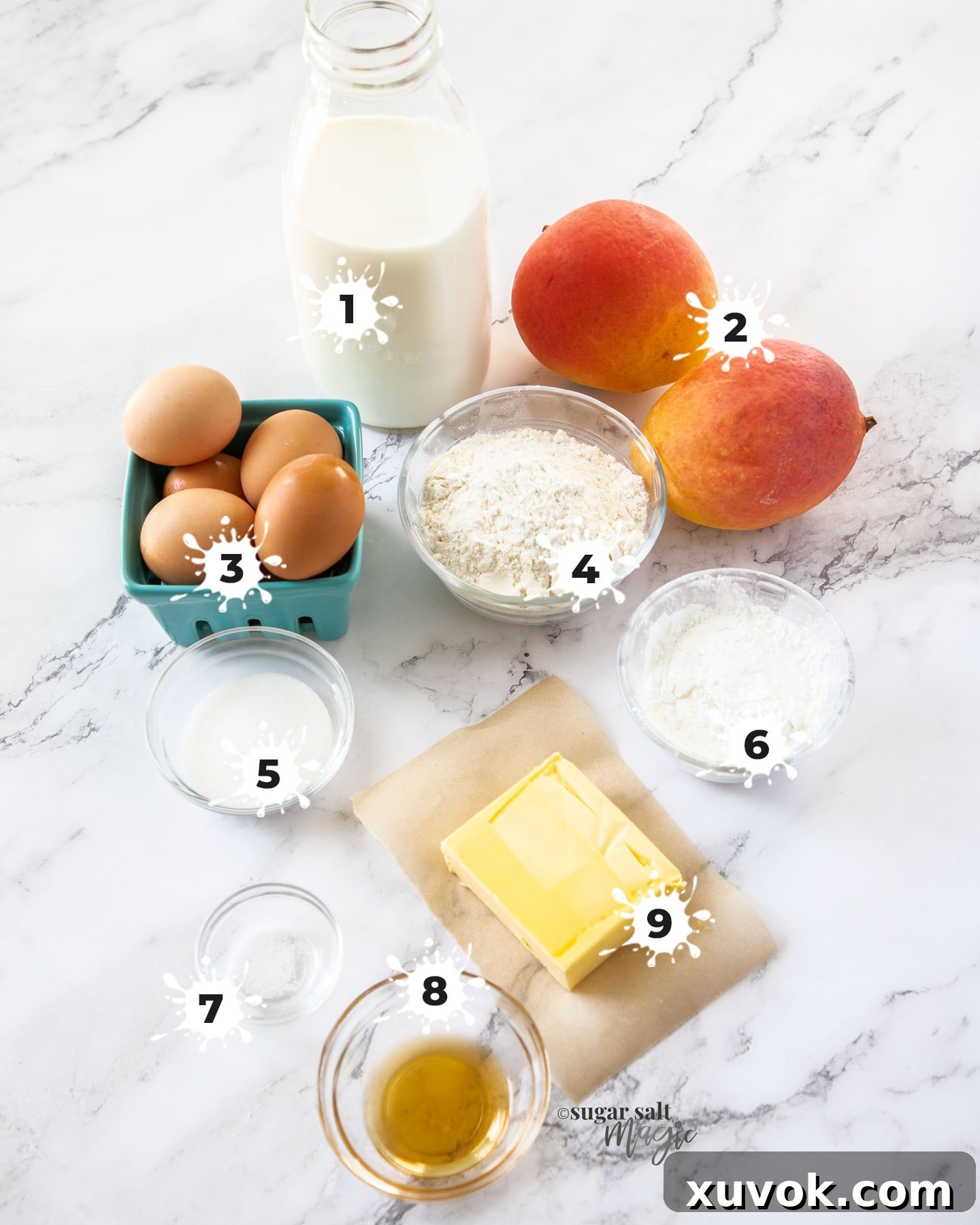 Ingredients for mango tart on a white marble surface.