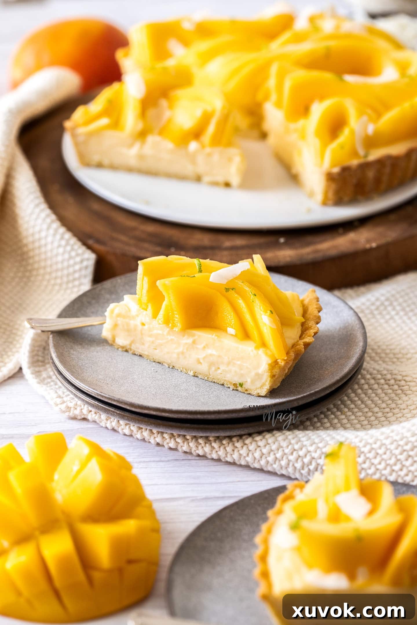 A slice of mango tart on a small grey plate.