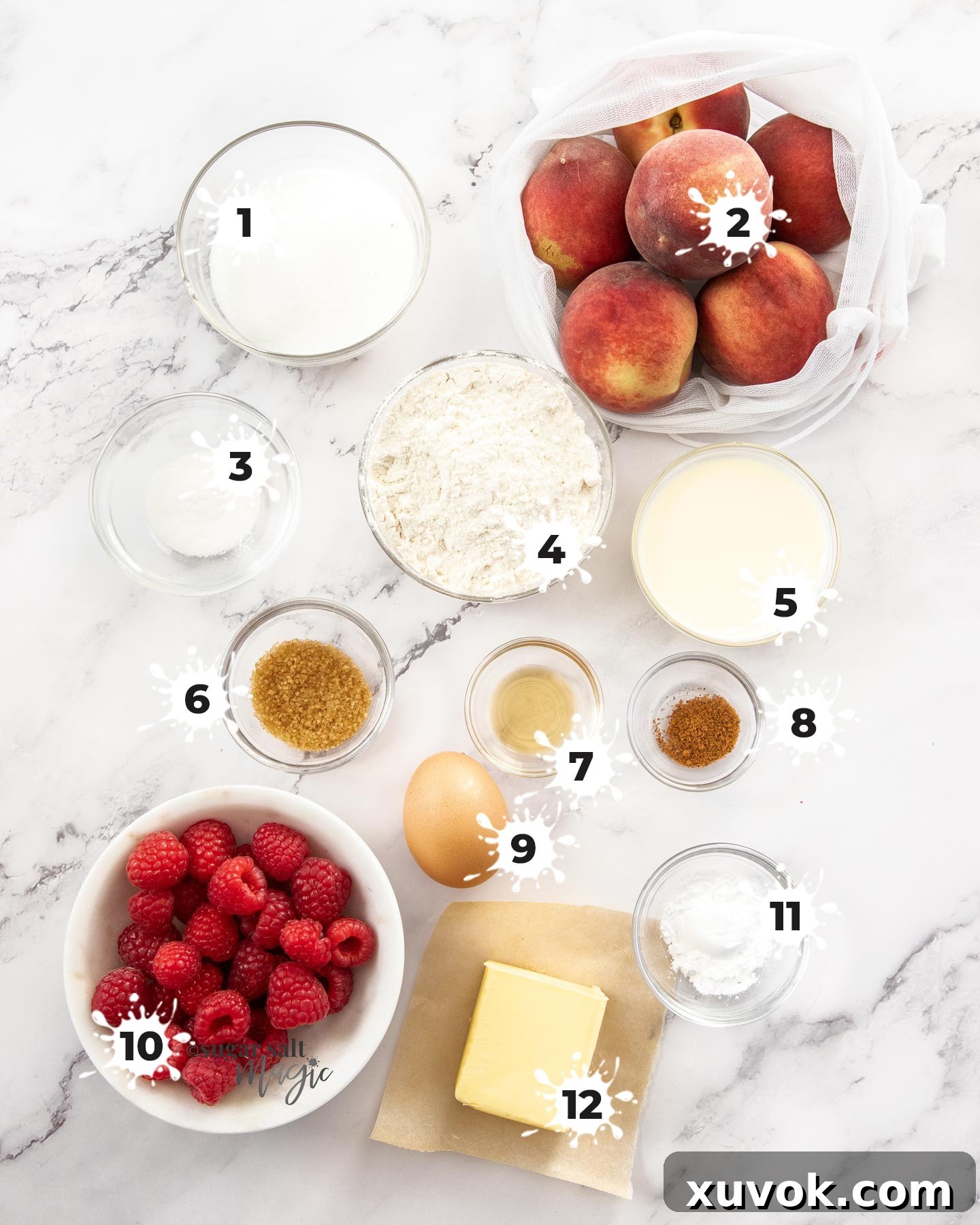 A carefully arranged collection of ingredients for raspberry peach cobbler on a sleek marble surface, ready for preparation.