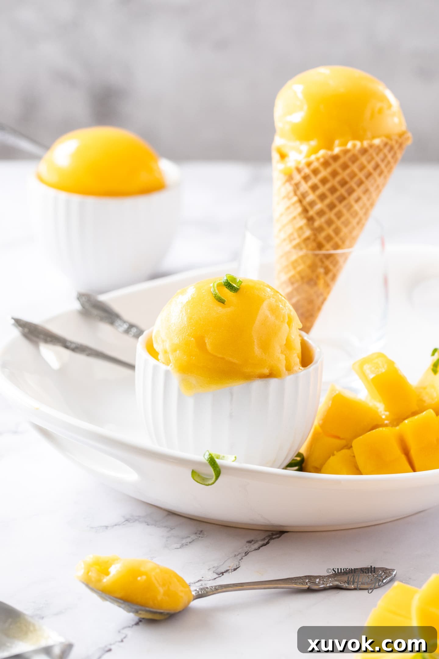 A crisp waffle cone holds a perfect scoop of creamy mango sorbet, promising a delightful treat.