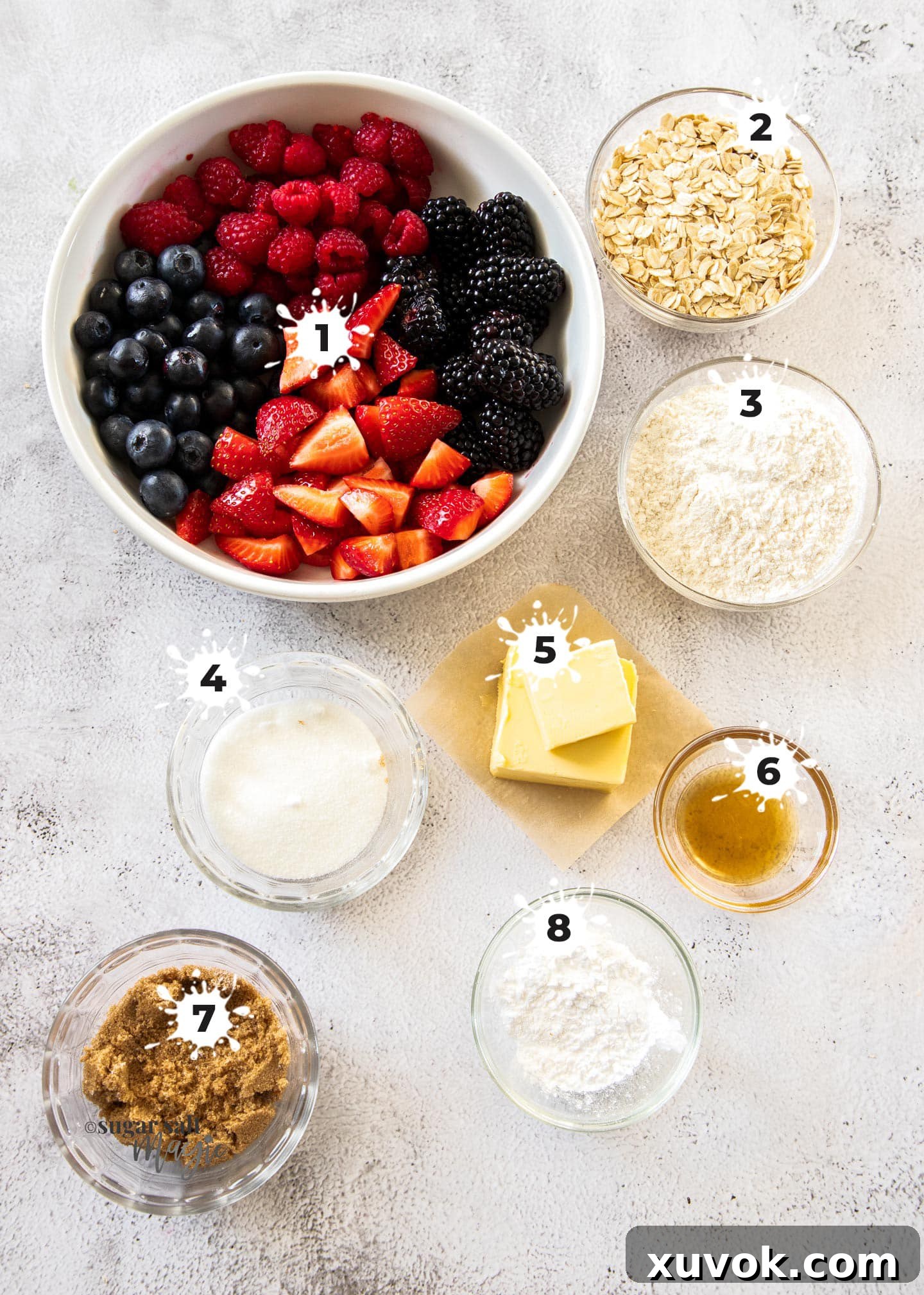 Assorted ingredients for mixed berry crumble laid out on a concrete countertop, numbered for easy reference.