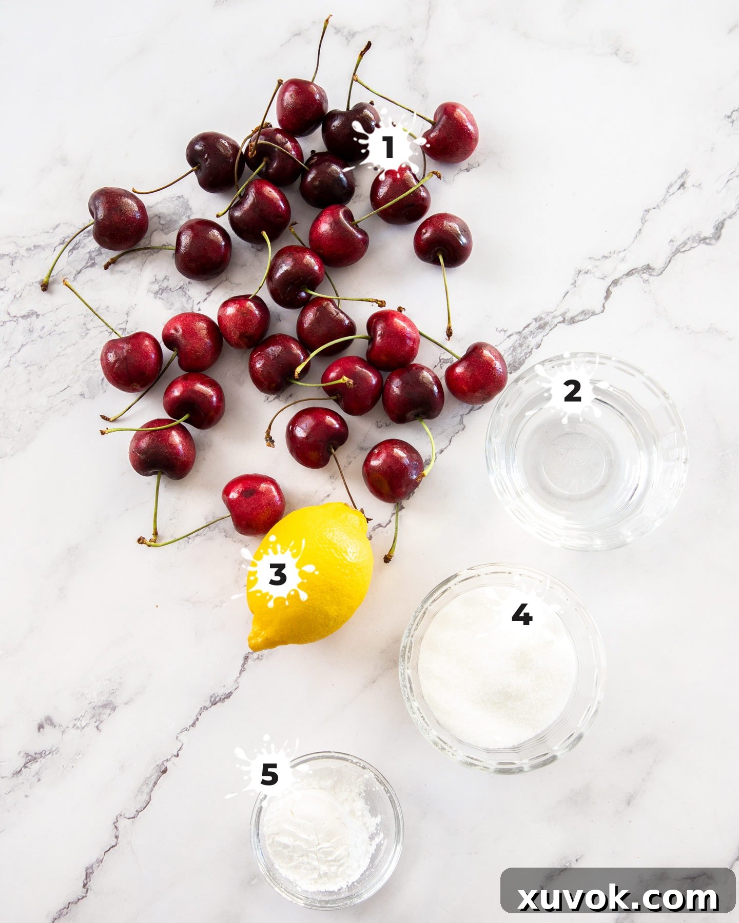 Ingredients for cherry sauce on a marble surface