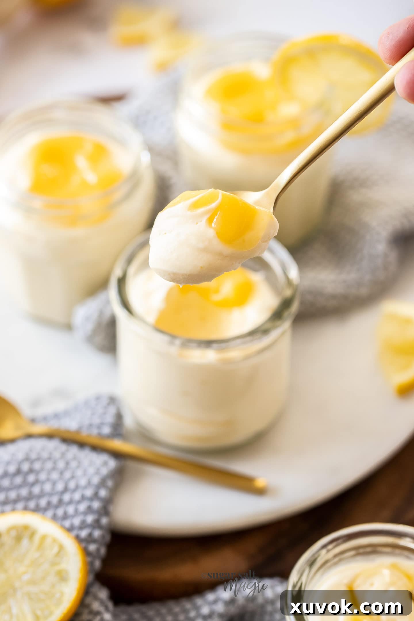 A close-up shot of a spoon filled with light, creamy lemon mousse, ready to be enjoyed, highlighting its smooth texture and delicate appearance.
