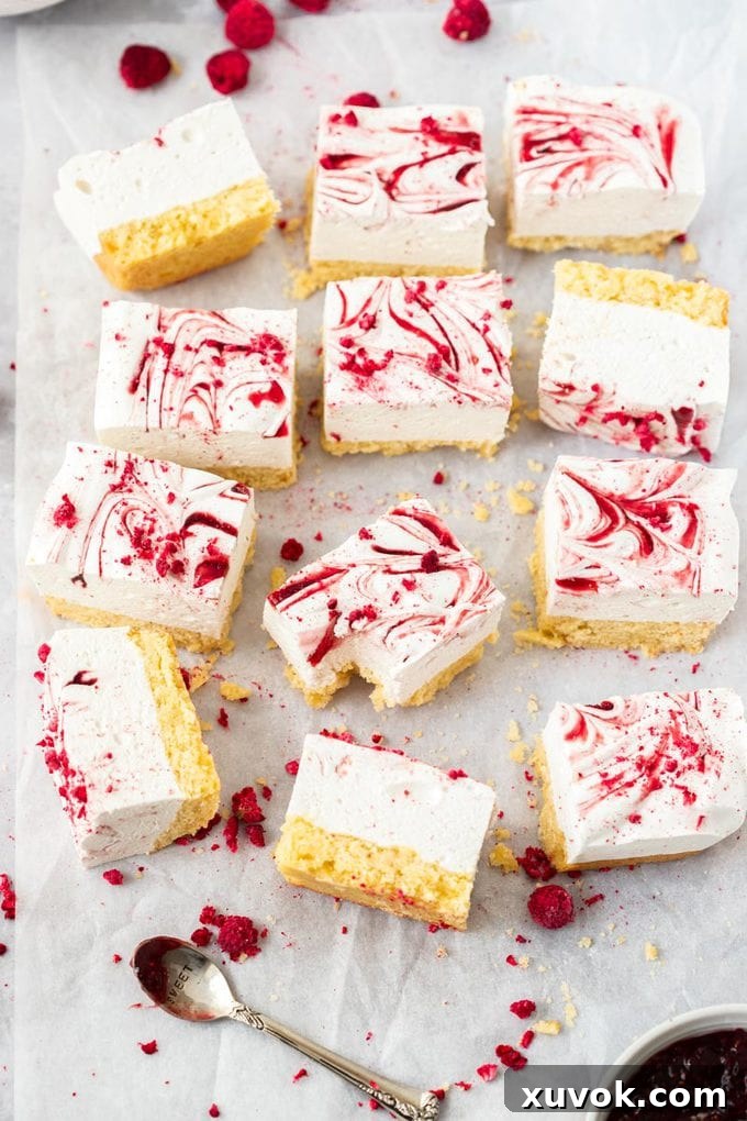 12 squares of marshmallow slice on a crumpled piece of white baking paper. 