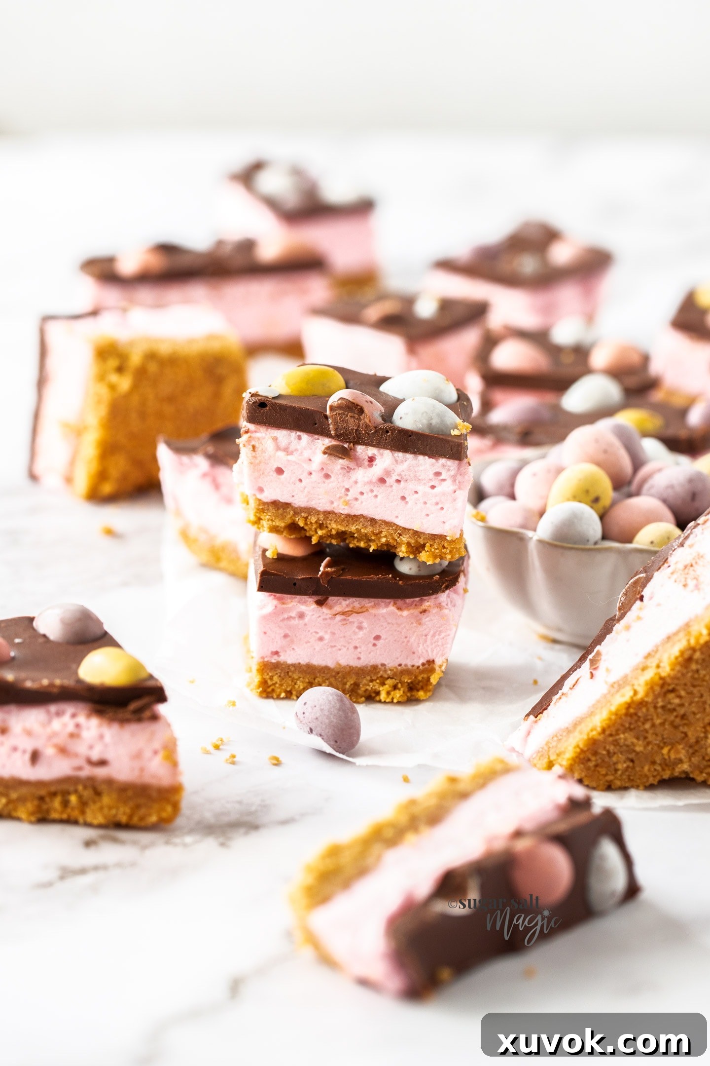 Two stacked pieces of easter egg slice filled with marshmallow.