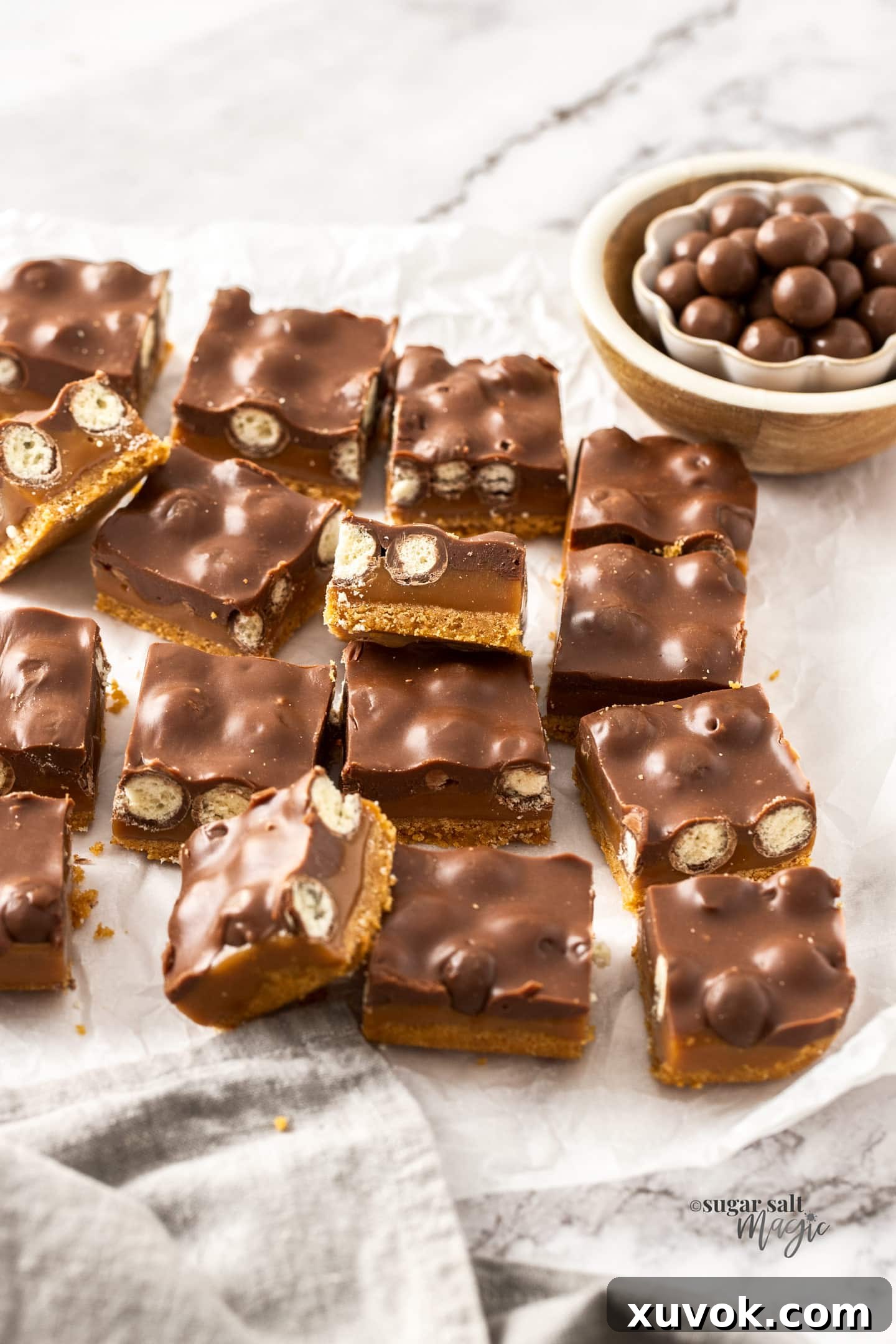 A full batch of set Caramel Malteser Slices, cut into perfect squares, ready for serving.