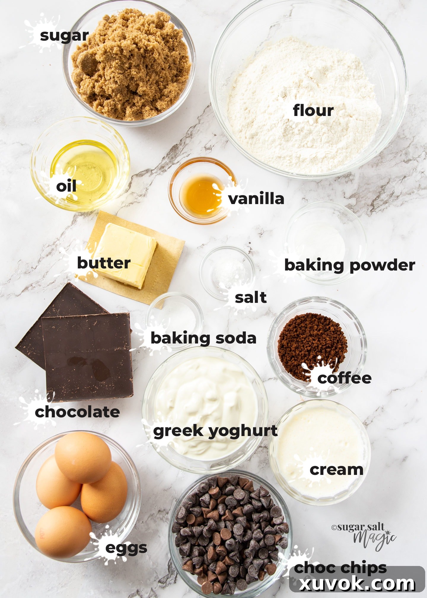 Carefully arranged ingredients for a delicious coffee bundt cake on a pristine marble surface, ready for baking.