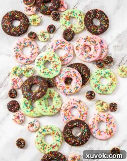 A batch of delightful donut sugar cookies on a marble surface, perfect for any occasion.