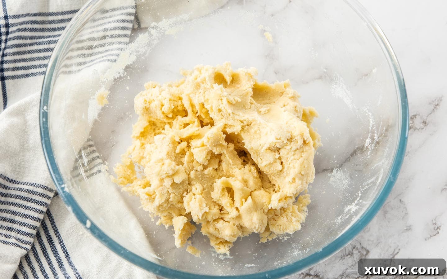 The perfectly formed Garibaldi biscuit dough, chilled and ready to be rolled out, resting on a lightly floured surface.