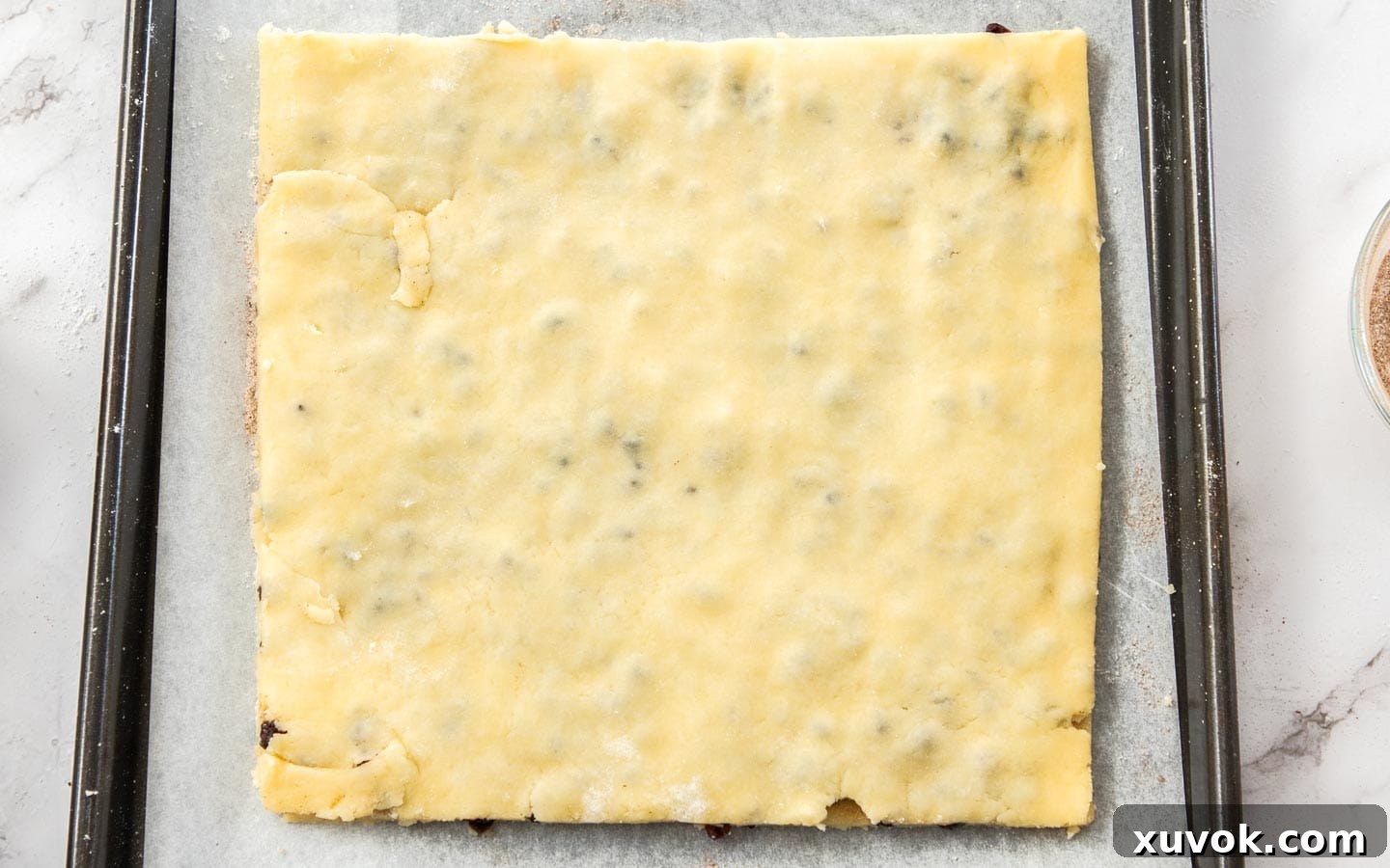 The second layer of buttery dough perfectly placed over the fruit-filled first layer, ready to be pressed gently together for Garibaldi biscuits.